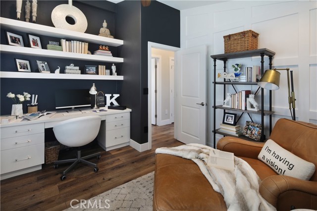 Third bedroom with built-in shelving and desk can also accommodate sleeping arrangements.