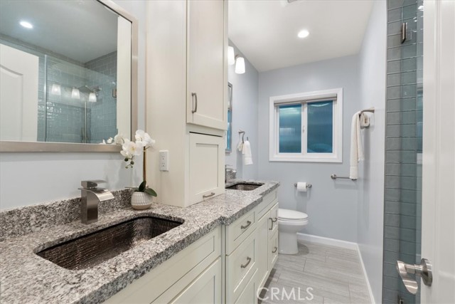 Main hall bath with dual sinks and beautiful shower.