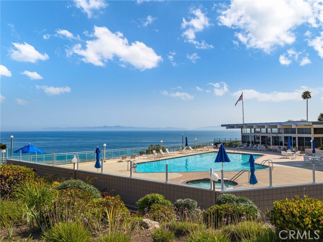 Pool and spa next to the clubhouse at the edge of the ocean.