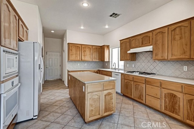 Kitchen. Door to The Garage Straight Ahead. Laundry Room To The Right Of The Garage Door.