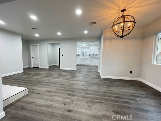 Living Room, Dining Room to the right, Kitchen and Main Entrance in the back.