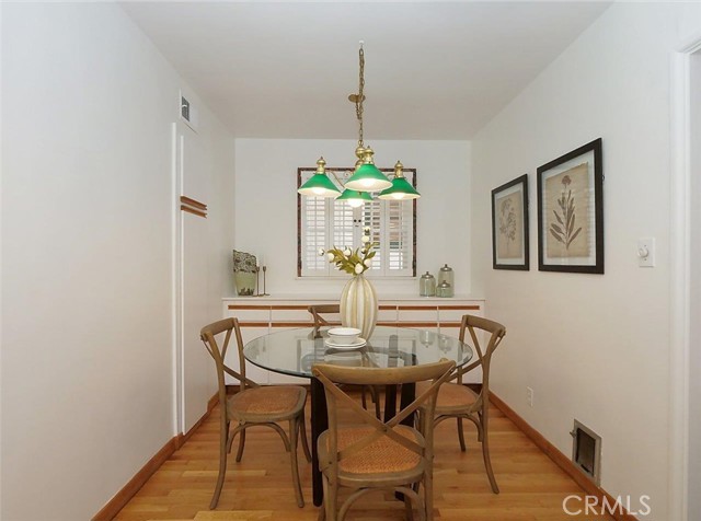 Breakfast nook by the kitchen with lovely wood floors and freshly painted walls.