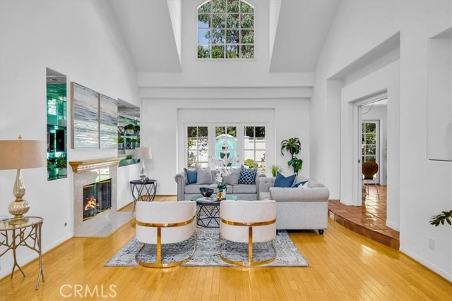 Spacious open and bright living room with high ceilings and cozy fireplace