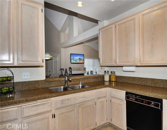 Spacious kitchen has can lights, granite(tiles) counter tops.