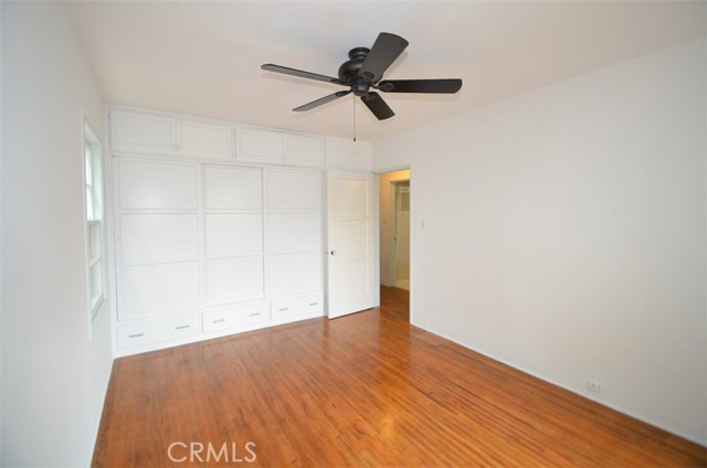 Bedroom 1 of lower unit with a wall of closets and even drawer space underneath.