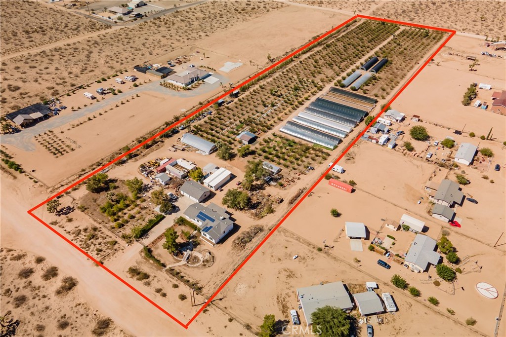 Live your dream freely on this 10 flat acre ranch, fully improved, completely fenced and gated with producing farm including 15 greenhouses: 11 are about 20'x120' and 4 are about 20'x96', 600 Ume plumb trees, fully sprinklered with fertilizer system, custom built home with finished basement, 960 sq ft manufactured outbuilding plus its own bath (building has been plumbed for kitchen), storage shed, storage container, covered work area, cooling room for fruits and vegetables. Large covered back porch overlooking the farm. Oversize 3 car detached garage and automatic gate to concrete driveway. Guests can enter through the walking gate over a charming bridge and walkway to the home's charming front porch. The house has an enormous living room with wood stove, very large kitchen with so much counter space, window over sink overlooking the farm, breakfast counter and dining room. Very well maintained by original owners, long life composition roof and laminate flooring on the main level. Primary bedroom suite, two additional bedrooms, 2 baths, den/office/possible 4th bedroom on main level plus a full basement with rooms created including laundry, bathroom, bonus area, bedroom areas. Property has electricity, solar contract, public water, septic. According to the County, the land can be divided into 1.25 acre parcels- Buyer to verify all info. Property is sold as-is. Low property tax rate and nice income from the farm. RS-1 Zone, other uses are possible according to the County. This may qualify for favorable USDA financing.