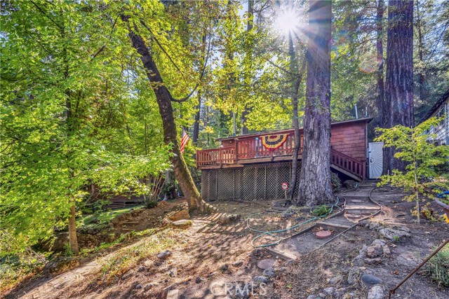 17151 Maple Shadows Drive Cobb, California Nestled in the trees in the desirable Whispering Pines community, this quaint 2 bed / 1 bath Fully Furnished home awaits! Set back from the road, the fenced parcel offers a quiet escape from the hustle and bustle of city life. Cedar shingle siding gives character and curb appeal. Inside find an open floorplan with several recent upgrades throughout. Crisp white kitchen with tiled countertops and propane range. Indoor laundry for convenience. Wood burning stove with plenty of firewood to keep you warm through your first winter! 2 cozy bedrooms and 1 updated bathroom with walk-in tiled shower. Large storage space under the home plus a bonus outbuilding that would make a great studio, storage space or workshop if desired. A natural spring provides water to this home at no charge! Take in the fresh Lake County air while enjoying local attractions such as the popular hiking and mountain biking trails at Boggs, Harbin Hot Springs, Adam Springs Golf Course and more! Opportunity awaits!