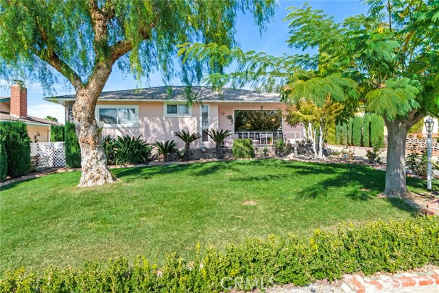 270 Slack Place Calimesa, California This cute Calimesa home enjoys many upgrades and amenities. The large front picture window overlooks the lush front yard and the rolling hills of the JP Ranch. The impressive list of improvements include: Dual Pane windows, remodeled baths, Rainsoft water treatment system, newer roof, energy efficient whole house fan, heat and a/c in 2013, new exterior paint, 2" blinds, recessed lightning and beautiful bamboo flooring. The layout is spacious with a raised hearth fireplace featuring a Lopi, brass door, blower insert. Long galley style kitchen with dining at one end. Upgrade cabinets and appliances, fixtures and an indoor laundry area. The bedrooms are large, the back family room is being used as a 3rd bedroom. Enclosed patio with storage closet and paver flooring, this is a fun game or hobby room. The baths are beautifully updated and the bamboo flooring adds a warm rich accent. The garage is oversized and private from the street view and there is room to park an RV behind the gate. Fruit trees and a fenced, raised bed garden area. This home is well cared for and has so much to offer.