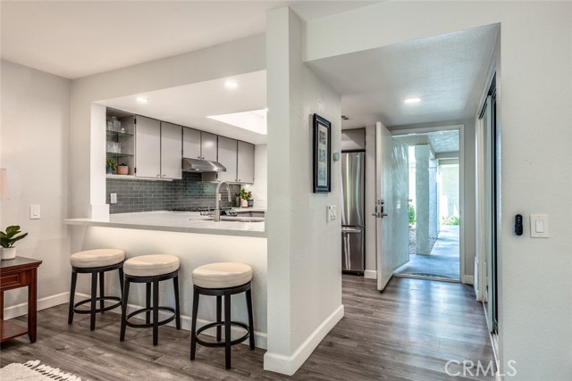 Kitchen island opens to living room and allows for a seated bar area.Check-out the lighting!