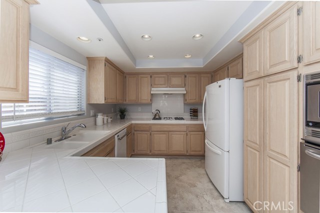 Kitchen with breakfast counter, built in stove, oven, microwave