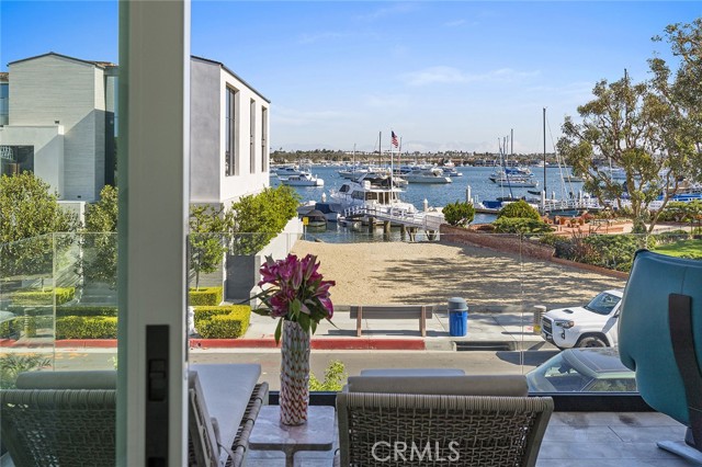 621 W Bay Avenue Newport Beach, California Balboa Peninsula beautiful custom home located on a prime corner lot across from a sandy launch beach to enjoy paddle boarding and kayaking. The home boasts Newport Harbor bay views from all three levels. This pristine residence is a complete turnkey home with designer touches. The floor plan and design of space with its indoor/outdoor integration offers a casual lifestyle great for entertaining. Highlights include an open floor plan on the main level with seamless entry to the patio. Second level features two ensuite secondary bedrooms, laundry room and a primary suite with a spacious custom closet, elegant bath and a covered view balcony. The third level has an ensuite bonus room that could be used as a bedroom or office that opens to an amazing rooftop view deck with a fireplace and BBQ area. Ideally located to embrace all that Balboa Peninsula offers including a very short distance to the sandy beach, bay front boardwalk, the Pacific Ocean as well as Balboa Village shops, restaurants and more.