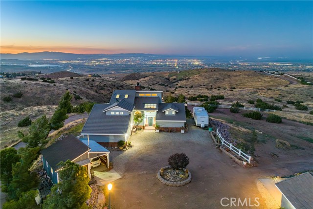 ***LIVE BEAUTIFULLY*** ONE-OF-A-KIND Country Living Custom Built Estate w/ A Guest Guest House That Offers Panoramic Lake & City Views Of The Entire Antelope Valley! OVER $225,000 IN CUSTOM UPGRADES/ AMENITIES! Perched On A Near 2.5 Acre Lot w/ Complete Privacy, This Hilltop Home Features A Main House, A Guest House, And A 12'X20' Workshop. The Main House Offers Nearly 2,400 Sq Ft In Living Space, Has 2 Downstairs Bedrooms w/ 2 Downstairs Full Bathrooms (One Of Which Was Just Completely Remodeled), NEW Windows, NEW Carpet In The Bedrooms, And NEW Exterior & NEW Interior Paint. The Great Room Has Soaring Cathedral Ceilings, Clerestory Windows, A Cozy Fireplace, And NEW 8 Ft Sliding Doors w/ Quarter Round Windows Above That Showcases The Breath-taking Views! The Spacious Kitchen Boasts Granite Counters, Tile Backsplash, LED Lighting, Shiplap Ceilings, A Farmhouse Sink, And Stainless Steel Appliances. The Upstairs Primary Suite Has A Private Redwood Deck That Offers Stunning Sunrises And Sunsets, Crown Molding, A Fireplace, A Retreat Area, And A Completely Remodeled Primary Bath w/ Custom Flooring, And A Stone-tiled Shower w/ 2 Shower Heads! The NEWLY Constructed Guest House Is Over 900 Sq Ft, Sits Just Over 100' From The Architecturally Unique & Attractive Primary House, And Is Built w/ 2X6 Construction All Set In An Attractive Farmhouse Decor. The Interior Of The Guest House Boasts An Open Concept w/ Shiplap Exposed Wood-Beam Ceilings, A Cozy Fireplace, A Modern Kitchen w/ Custom Cabinetry, Farmhouse Sink, Stainless Steel Appliances, A Living Room w/ Vaulted Ceilings And Window Showcasing The Views, And A Primary Suite w/ A Custom Barn Door, And Primary Bath w/ A Custom Vanity And Stone-tiled Shower w/ A Rainfall Showerhead! Additional Amenities Include 2 Attached Garages And 1 Detached Garage, A 7,500 Gallon Water Tank, 2 Sheds (10'X10' & 8'X8'), 6'X9' Generator House w/ 20 KW Detroit Diesel Generator, Fire Sprinklers, And More Than 50 Mature Trees! Located Just A Few Miles From The 14 Freeway, This Custom Built Country Living Home w/ A Guest House That Offers Peace And Tranquility, Is Truly A MUST See!