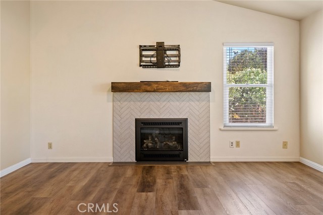 The newer gas fireplace features an attractive tile surround and rustic mantle.