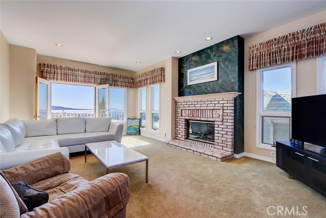 Relax in ocean view family room with custom fireplace