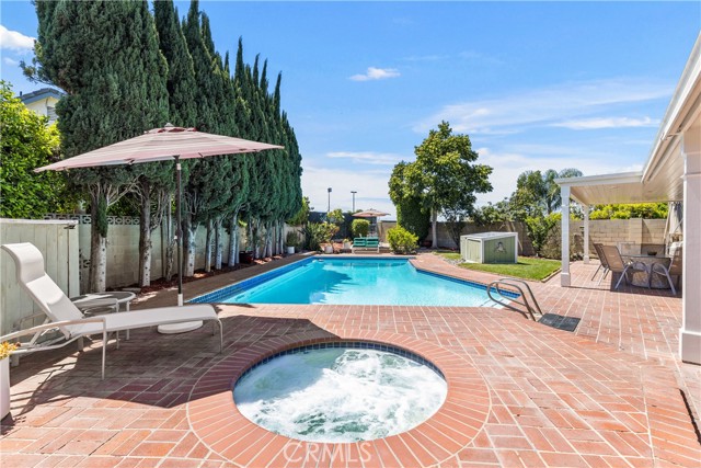 Entertainers dream backyard with custom brick work, deep swimming pool, and jacuzzi.