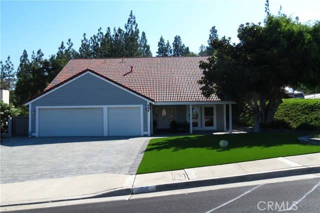 Welcome to this beautifully upgraded Anaheim Hills 2-story home boasting 2,703 sq. ft. of spacious living on a desirable 8400 sq ft corner lot. With 4 large bedrooms and 2.5 baths, this residence offers comfort and style for the whole family. Step inside to find a fresh palette with brand new interior and exterior paint. The inviting living room and elegant dining room provide ample space for entertaining. The heart of the home is the cozy family room featuring a built-in entertainment center and two charming fireplaces—one in the family room and another in the luxurious master suite. The chef’s dream kitchen is equipped with soft-close hinges on all cabinets, a convenient lazy Susan, and hidden appliances that blend seamlessly into the cabinetry. Enjoy brand new built in stacked oven and air fryer, an electric stove top, dishwasher, and ample cabinet space, including a stylish wine rack and see-through glass cabinet doors. A beautifully designed breakfast bar adds an element of sophistication, making it the perfect spot for casual dining or morning coffee. Retreat to the master bedroom, featuring inviting perspectives of your thoughtfully designed outdoor space and a cozy fireplace that adds warmth and ambiance. The upgraded ensuite bathroom featuring double sinks and a separate soaking tub. One of the additional bedrooms also showcases lovely city views, while the guest bathroom is equipped with double sinks and a bathtub for added convenience. Step outside to your private backyard, complete with fig and apple trees, perfect for enjoying the California sunshine or hosting summer gatherings. Both the front and back yards are beautifully landscaped with pet-friendly artificial grass, providing a low-maintenance, lush environment for your furry friends to enjoy. Recent upgrades include a brand new hot water heater, new central heating and air conditioning, and all new flooring throughout. The home also features a spacious 3-car garage with finished floors, drywall, and extra storage, ensuring both functionality comfort, and organization. Located just 3-4 blocks from a grocery shopping center and within walking distance to a daycare and elementary school, this property is perfectly situated for families. Plus, older kids can easily walk to high school. Enjoy the convenience of easy access to the 91, 55, and 57 freeways for all your commuting needs. Don’t miss your chance to own this exceptional Anaheim Hills home—schedule your showing today!