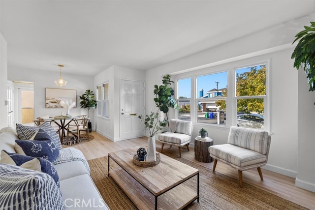 Living area with adjacent dining area, large windows, tons of light