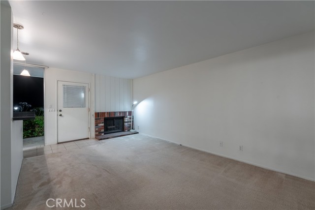 Living room with wood burning fireplace.