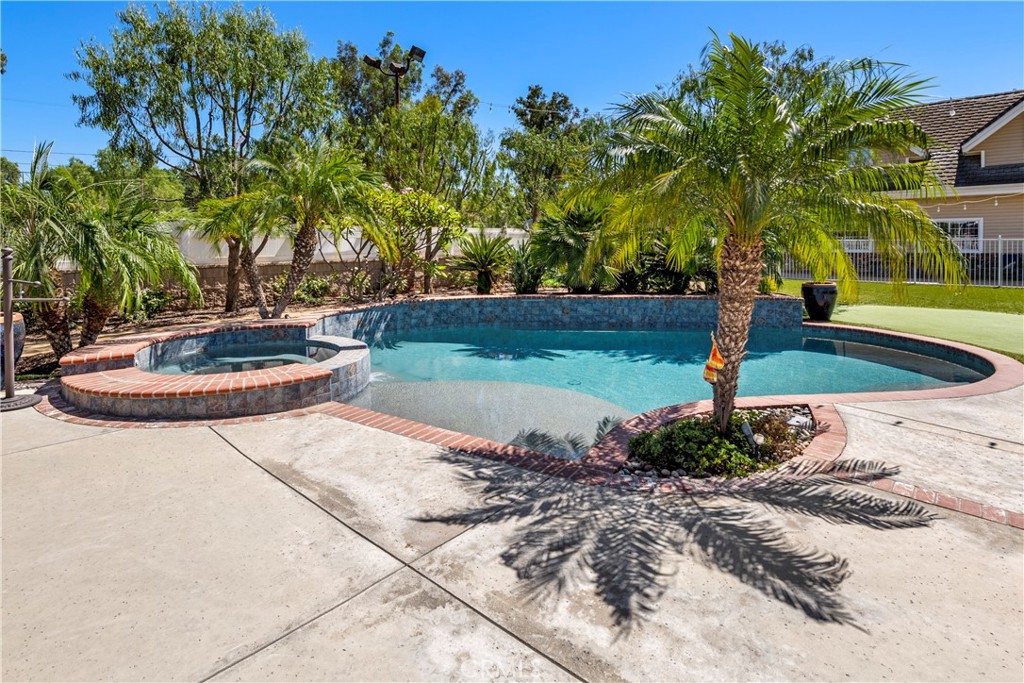 Iron Fenced backyard w/ artificial grass.