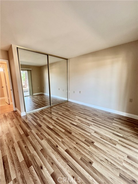 View of second bedroom's mirrored closet doors