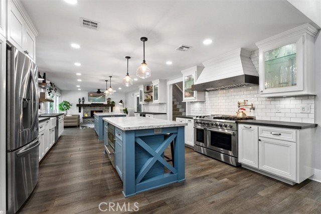 The remodeled kitchen offers sleek countertops, quality cabinetry, stainless steel appliances, and a generous dining space that flows effortlessly into the family room.