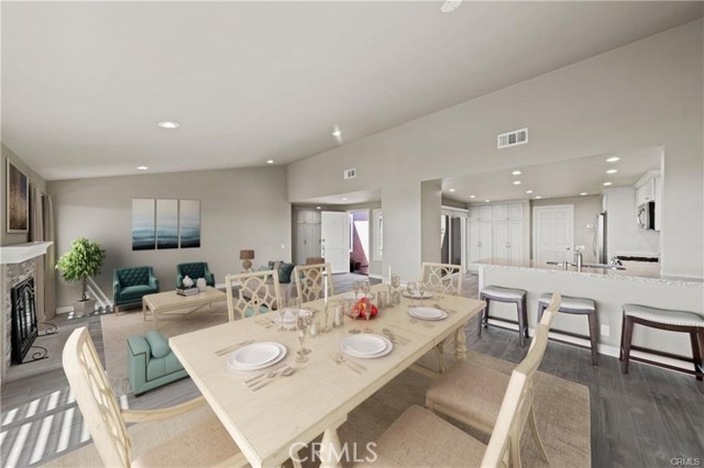 Looking from the dining room slider towards the kitchen and the front door. The vaulted ceilings and open floor plan create a 