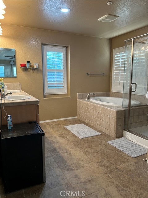 Large bath with stub and walk in shower with dual sink vanity