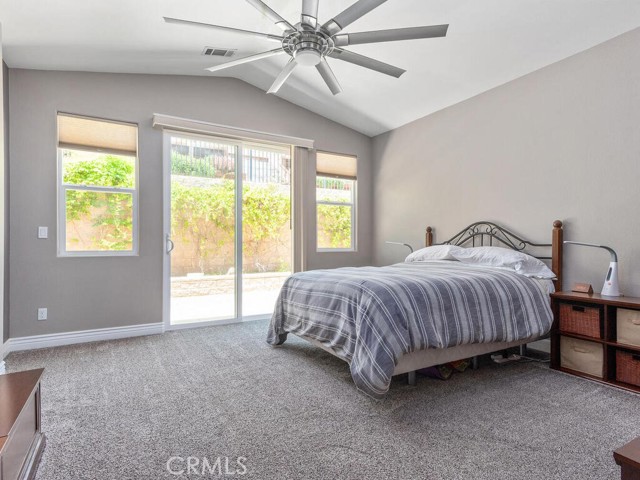 Primary bedroom with sliding doors to rear yard