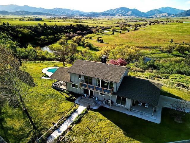 Panoramic views and amenities set this unique, secluded property apart. With over 24 acres overlooking the Shasta River to the north and Mt. Shasta to the south, it’s minutes to town and the I-5 (45 minutes to Ashland, OR). Inside, solid red oak floors contrast with generous windows and rock fireplaces in this comfortable retreat. Cook’s kitchen includes convection oven, glass cooktop and oversized double sink. Upstairs a huge master suite with sitting area features wood stove and floor to ceiling windows with views from two decks. Oversized master bathroom has double vanity, jetted tub, hot rock sauna, and walk-in double shower. Outside, enjoy the solar heated in-ground pool and oversized covered deck. There’s plenty of room for hobbies with an organic garden, chicken coop/run, 2 stall horse barn, tack room, hay storage, fenced irrigated and dry pastures, large shops and equipment sheds. Second 980sqft residence provides room for family or friends. Wholly owned 10.8Kw net-metered solar system provides power. This is one of the finest private settings in the valley.