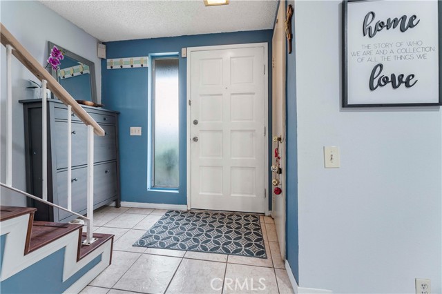 Entry with tile flooring, closet to the right, stairs lead to spacious bedrooms and full bath.