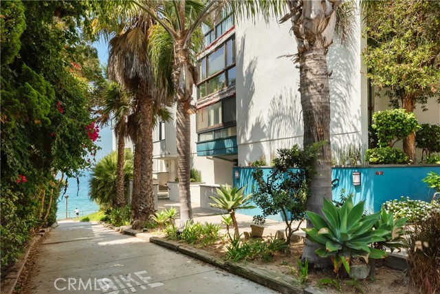 There is a public walkway to the beach next to the building's entry door