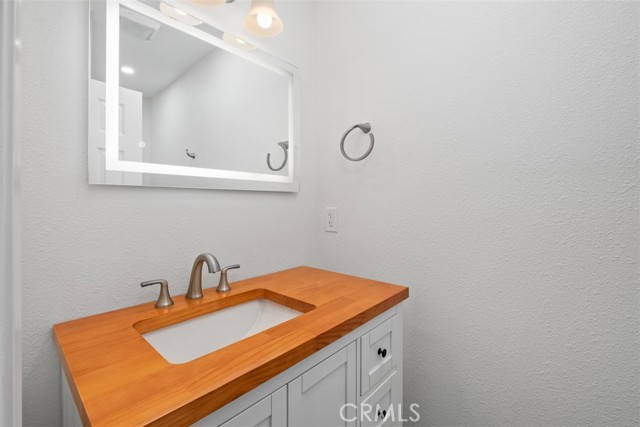 Secondary bathroom with lighted mirror.