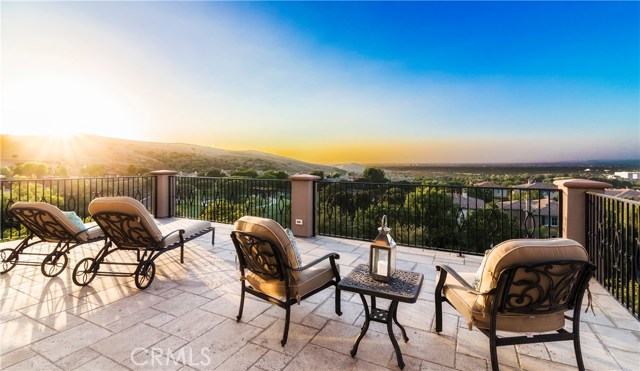 29 Balcony Irvine, California Experience the luxury and solace of this Vicara Plan 3 estate located near the top of prestigious Quail Hill! MUST-SEE panoramic views of Orange County and City Lights for miles! Enter this private residence through an iron gate and quiet courtyard to a captivating formal entry. Kitchen is a chef's dream featuring top-of-the-line stainless steel appliances, upgraded 6 burner stove, granite counter-tops, and an over-sized island with counter top seating. Cozy up next to the extra large open family room with fireplace. Gather in the elegant formal dining room with classic french doors leading to a relaxing courtyard, tranquil fountain, and seating area. Experience the splendor and beauty city lights views for miles on one of the largest private balcony. Enjoy the backyard oasis featuring a fountain, built in BBQ range, stone fireplace, and convenient counter top seating. Downstairs bedroom is the perfect retreat for guests with its own en-suite bathroom and closet. Retreat to the master suite where comfort and leisure await with a spectacular balcony, private office, and your own private gym. Notable direct access spacious 3 car garage great for storage and vehicles. Enjoy tree-lined streets, hiking/biking trails, 3 community pools, a fitness center and world-class amenities. Home is conveniently located within award-winning Irvine Unified School District and offers nearby access to Quail Hill shopping center, Irvine Spectrum Center, John Wayne Airport, Laguna beach, and more!