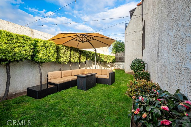 The backyard located directly outside 2603 Rockefeller Lane #3,  the HOA's common areas include functional and versatile outdoor spaces.