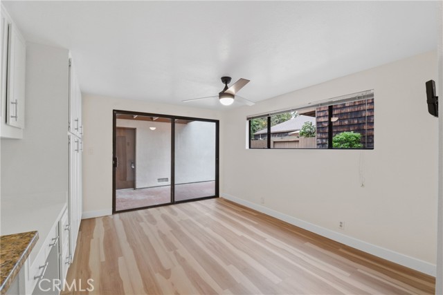 Light, bright family kitchen with new laminate flooring, decorative ceiling fan with light,