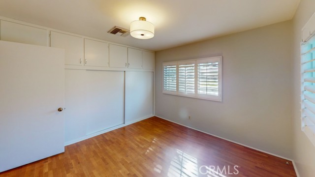 Front bedroom with wall of built in storage