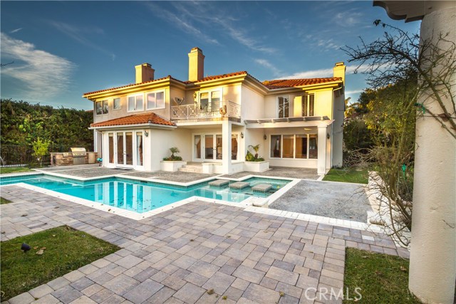 Pavers and in ground pool with a spa