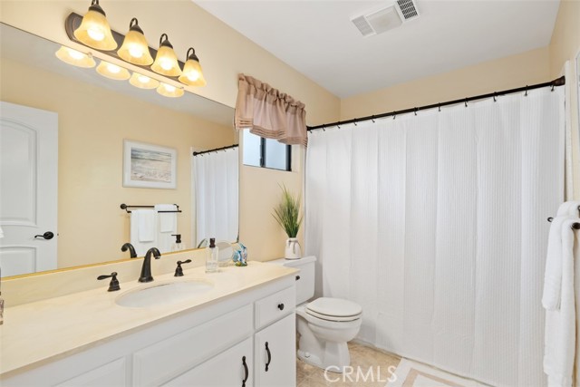 Master bathroom with tub/shower, low flow toilet, window and updated faucet and light fixtures.