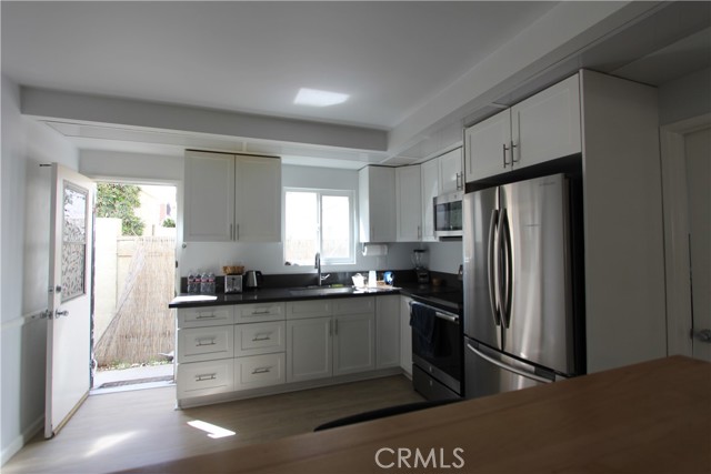 Unit C- Kitchen. Back door allows cross ventilation and easy access to double garage.