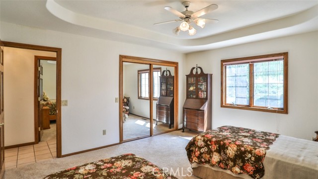 Second of the 3 downstairs bedrooms.  Notice the coffered ceiling with fan, mirrored closet doors