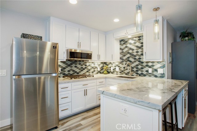 2559 Rimcrest Road Brea, California You will love this one-of-a-kind studio that has been designed to maximize the living space to the fullest. This beautifully decorated studio looks like a model unit with the custom tile floors throughout and custom windows that bring in wonderful natural light. The gorgeous kitchen boasts quartz countertops accented with a beautiful backsplash, all new custom cabinets, a breakfast bar, all new appliances including refrigerator, microwave, and gas cooktop. The spacious bathroom has been designed with a large walk-in shower. Other features include a wall-mounted 65" TV, a Mini-Split A/C and Heating, garage parking, and plus utilities included (gas, water electric, wi-fi and cable). Tenant can enjoy the community features including swimming pool, Jacuzzi, and tennis courts.