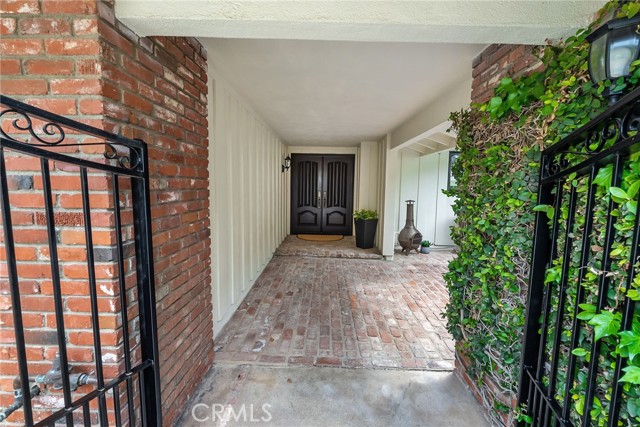 Enter from the driveway into a gated courtyard and patio.