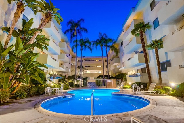 View of sparkling pool with lush tropical ambiance. View of sparkling pool with lush tropical ambiance.