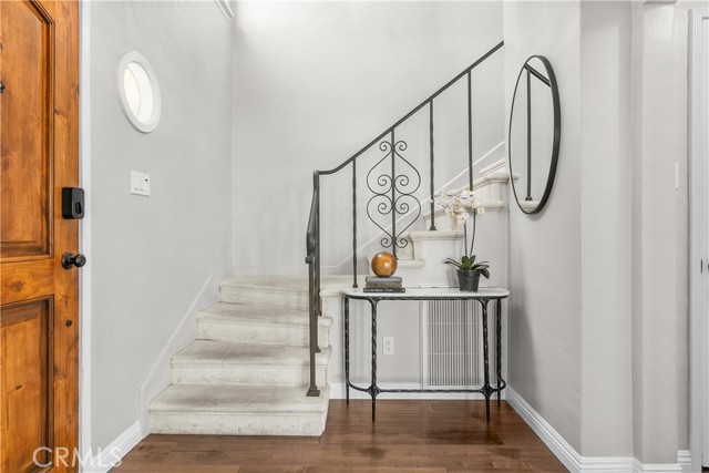 The entry of 6401 Corsini Pl and stairway to the upper level bedrooms.