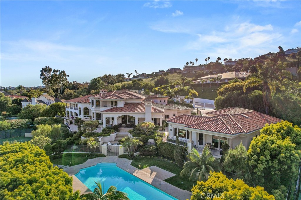 Nestled within the exclusive gated community of Bear Brand Ranch in Laguna Niguel, this magnificent estate illustrates luxury living. This stunning property was rebuilt, boasting 10 bedrooms, 11.5 bathrooms, and an estimated 13,500 square feet of living space on a sprawling 1.41-acre lot, Offering the ultimate in privacy and elegance. Upon entry, you are greeted by a grand foyer with soaring ceilings and exquisite custom woodwork throughout, setting the stage for the unparalleled craftsmanship found throughout the home. The spacious living areas are bathed in natural light and feature custom-designed furniture, creating an ambiance of sophistication and comfort. The gourmet kitchen is a chef's delight, featuring top-of-the-line appliances, custom cabinetry, and a large island, all accented by custom woodwork. The adjacent dining room offers a perfect setting for formal meals, while the cozy family room with a fireplace provides a warm and inviting space to relax. The luxurious primary suite is a private sanctuary, complete with a spa-like bathroom, a sitting area, and a private balcony overlooking the meticulously landscaped grounds. Each additional bedroom is generously sized and features its own en-suite bathroom, providing comfort and privacy for family and guests alike. Outside, the resort-style grounds are an entertainer's dream, featuring a tennis court, a fully renovated pool and spa, and multiple outdoor seating areas. The expansive lawn is perfect for hosting events or simply enjoying the serene surroundings in total privacy. Additional features of this exceptional estate include a six-car garage, a wine cellar, a home theater, and a gym. Located just minutes from world-class beaches, shopping, dining, and entertainment, this is a rare opportunity to own a truly exceptional property in one of Orange County's most coveted communities. Experience the embodiment of luxury living in Bear Brand Ranch. Schedule a private tour today and discover the extraordinary lifestyle that awaits you!