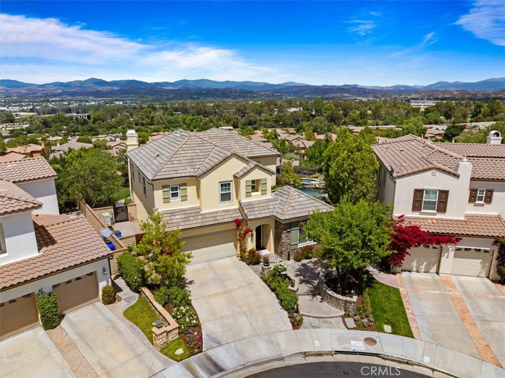 Luxury Living Redefined Behind the Gates of Westridge – The Yard of All Yards!

Welcome to this extraordinary executive residence nestled in the prestigious, gated Westridge community of Valencia. A rare blend of elegance, comfort, and breathtaking natural beauty, this 4-bedroom plus library/office estate boasts unrivaled panoramic views of city lights, the picturesque Santa Clarita Valley, and seasonally snow-capped mountains. Step inside to discover refined craftsmanship throughout, including rich wood flooring, designer crown molding, custom built-ins, and thoughtfully curated lighting. The heart of the home is a newly remodeled chef’s kitchen, showcasing an expansive quartzite island, GE Café appliances, a farmhouse sink, designer backsplash, under-cabinet lighting, and a butlers pantry with slide out hot beverage center for everyday indulgence. The adjacent family spaces seamlessly connect for effortless entertaining. Each of the four spacious upstairs bedrooms features its own ensuite bath (2 bedrooms ensuite, 2 bedrooms share a Jack & Jill with dual sinks), ensuring privacy and comfort for all. Remodeled secondary bathrooms, fresh light fixtures, elevate the home’s luxurious aesthetic.

Step outside to The Yard of All Yards—a true entertainer’s paradise. Revel in your private sparkling pool with beach entry, waterfall and spa, dine al fresco at the outdoor bar and built-in BBQ. Enjoy a covered private patio area, or unwind by the outdoor fireplace as you take in the sounds of a tranquil fountain and sweeping vistas. Children and guests alike will enjoy the lush grassy area, while mature landscaping, a tranquil fountain, and enhanced lighting create an inviting ambiance.

This home also features a host of smart and energy-efficient upgrades, including OWNED solar system with solar panel washing system, a whole house fan, newer AC unit (2024), newer pool pumps, retractable screens, and 4 year old water heater. Additional highlights include a new garage door opener, shutters throughout, and fresh interior paint, new carpet in all bedrooms, and refreshed exterior paint. Truly turnkey with potential inclusion of appliances, this home is a rare opportunity to own one of Westridge’s most exceptional properties—where elevated living meets timeless style. Views. Luxury. Lifestyle. This is the one!