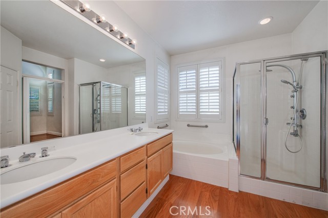 Master dual sink vanity, tub and shower.