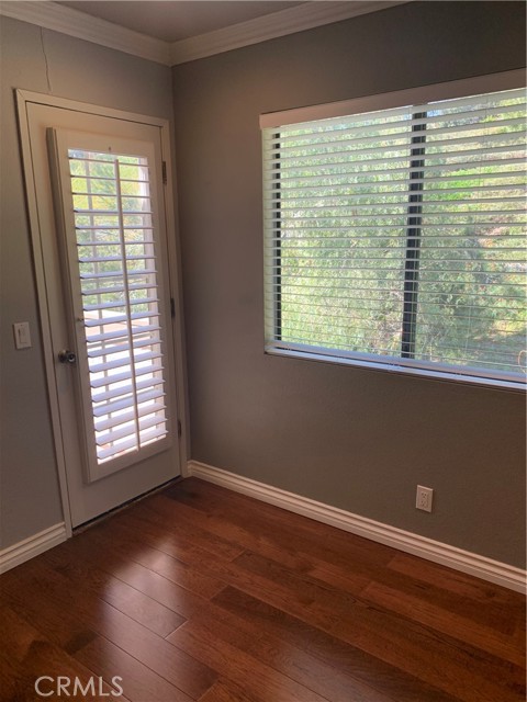 Bedroom #2 has door to patio deck and custom wood shutters