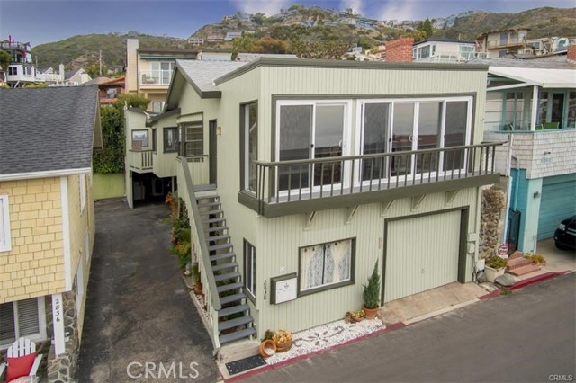 2838 Wards Terrace Laguna Beach, California Three apartments located on the second row from Laguna's famous Victoria Beach! One unit in the rear is very private, and there are two additional units in front, one upstairs and one at street level. There are ocean views from the upstairs unit. This is an excellent opportunity to redevelop the property into a single family home, on a street with several ocean-front homes, or for continued use as income property. The two larger units in front may be combined into a single 2-level beach house, and the rear apartment may be used as a detached studio, office or gym. The three units currently generate $8,790 in monthly rents.