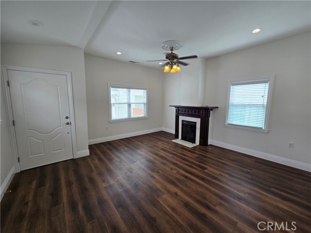 Entryway and living room complete with a working fireplace.
